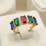 vibrant gold ring adorned with colorful gemstones,