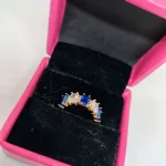 vibrant gold ring adorned with colorful gemstones,