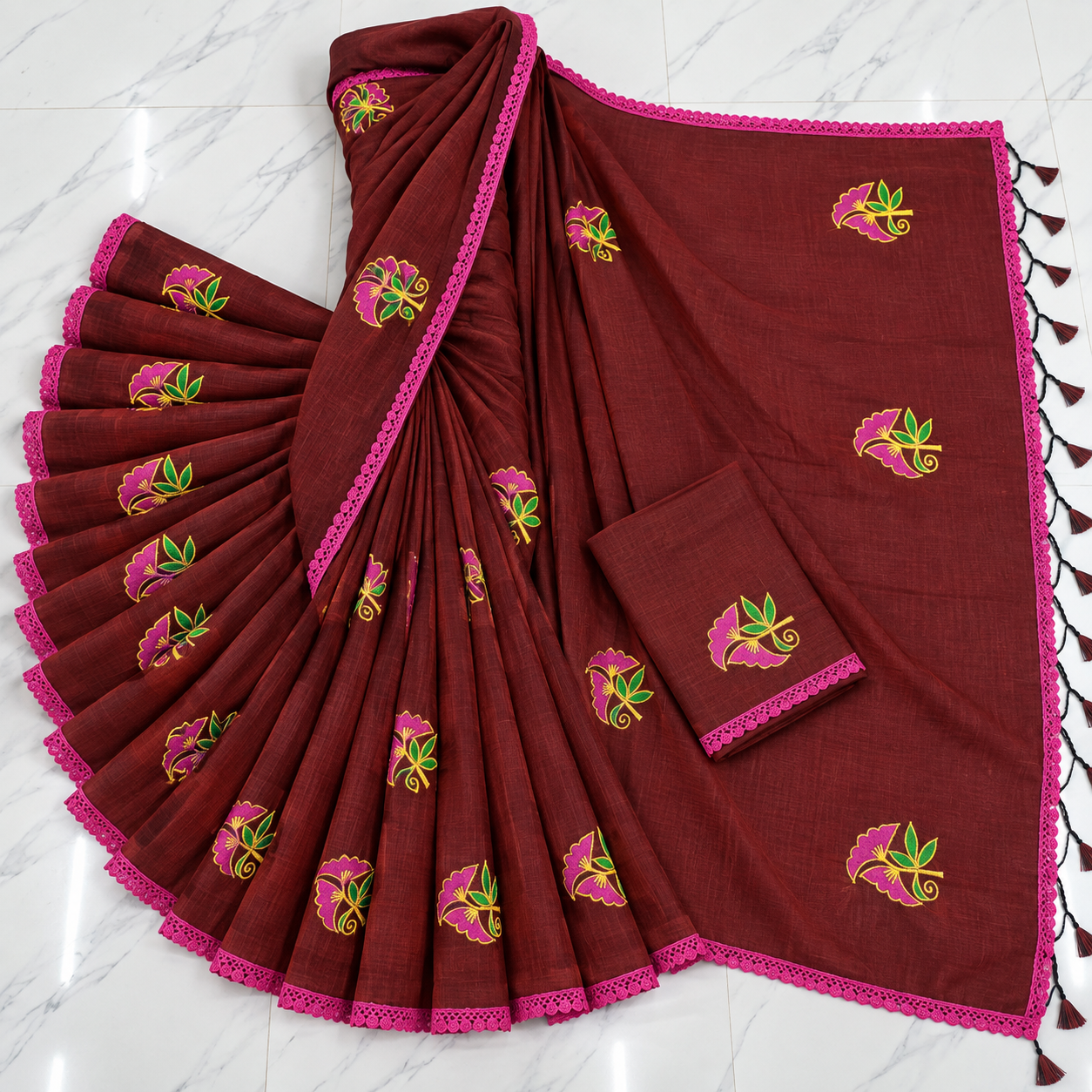 Exclusive deep maroon cotton saree with embroidery and lace border.