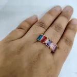 vibrant gold ring adorned with colorful gemstones,