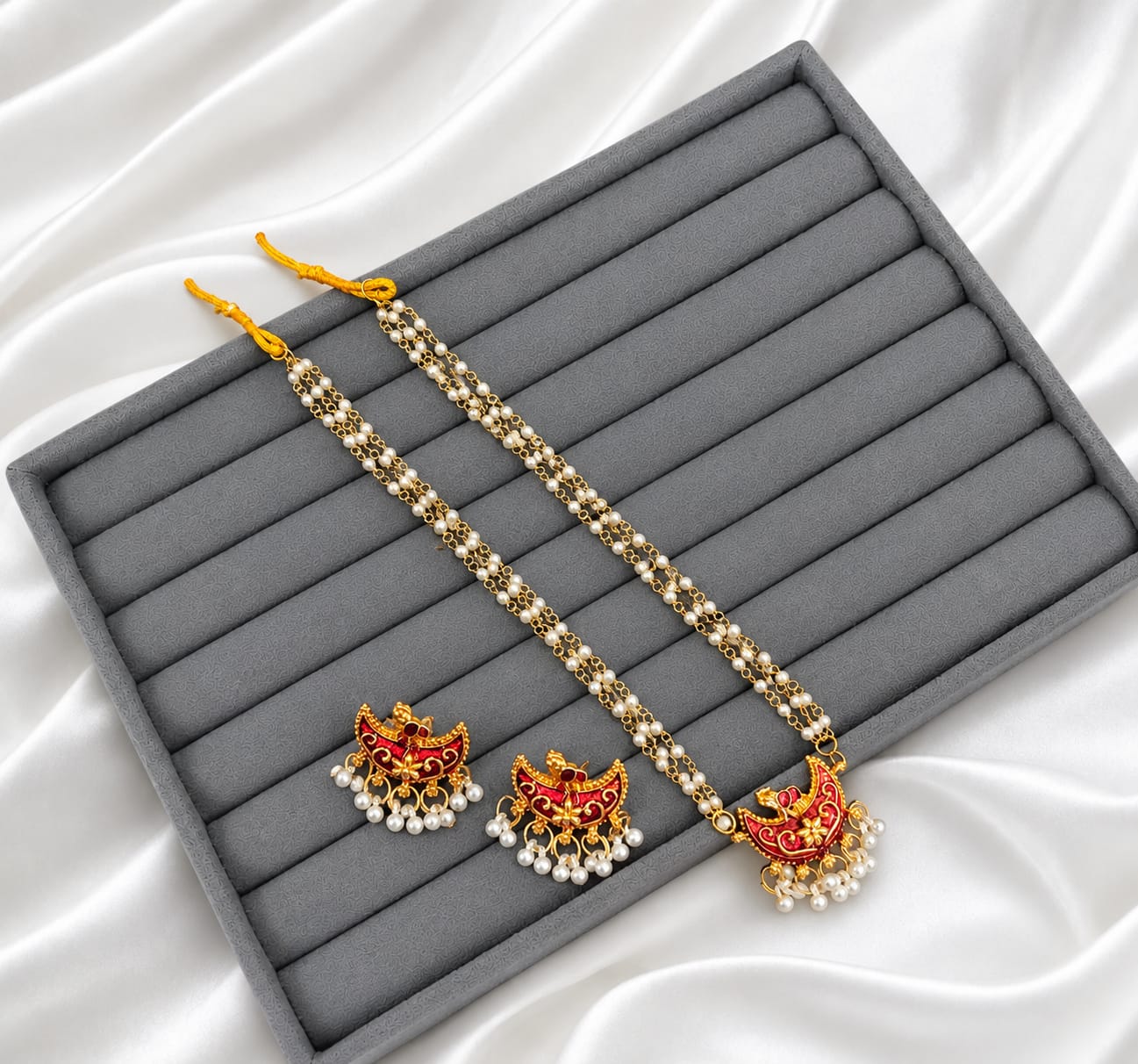 Adorn yourself with a touch of tradition in an exclusive pearl and Meenakari jewellery set!
